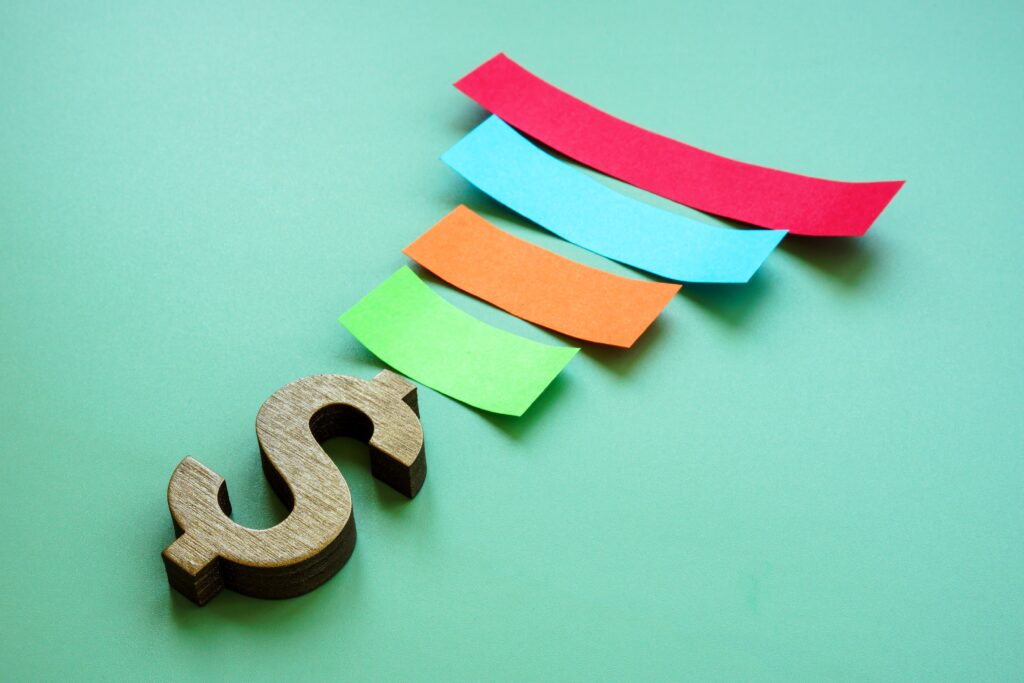 paper strips and dollar sign showing a sales funnel